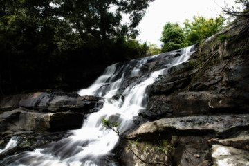 Fototapeta na wymiar White waterfall in the forest.
