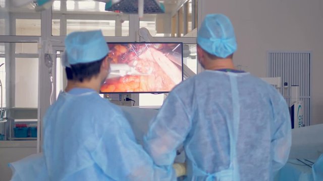 Team of surgeons performing a surgery using an robotic equipment.