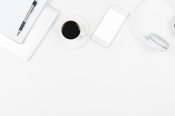 Creative white workplace with blank cellphone