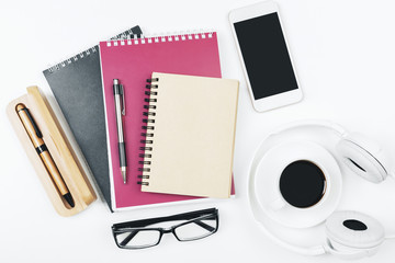 Creative white workplace with empty smartphone
