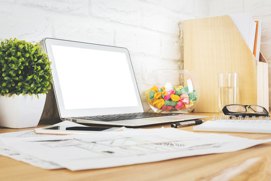 Creative designer desk with blank laptop