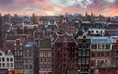 Zelfklevend Fotobehang Roofs of Amsterdam at sunset,  Netherlands. Top view of old-time houses. © Antonel