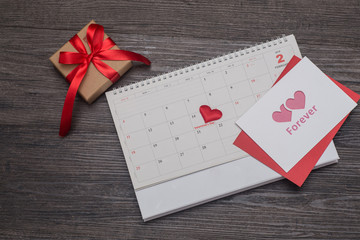 Valentines day background, card and gift on the calendar