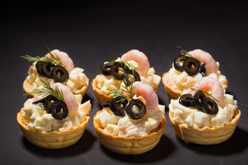 salad with shrimp in tartlets on a slate of black slate