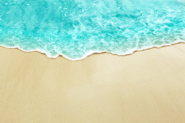 Fototapeta na wymiar Turquise color sea wave on the sunny sandy beach