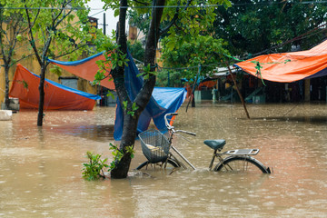 Bike in floodwater from a typhoon in the Old Town of Hoi An, Vietnam.