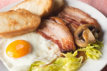 fried egg, bacon toast and mushroom for breakfast
