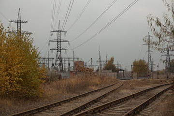 Industrial foggy landscape - old abandoned industrial zone in autumn forest