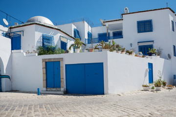 Fototapeta na wymiar Sidi Bou Said. Tunisia. Houses and streets of the magical blue and white city. view of the facade of the house. windows and doors