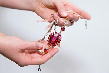 Woman’s hand with beautiful red necklace