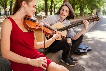 street music duo group performing in a park. free spirits hippie romance concept