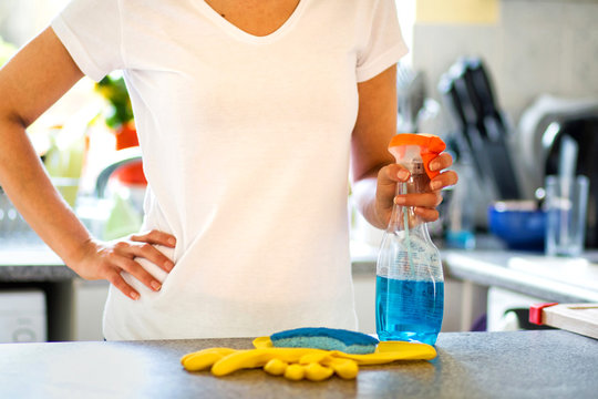 Woman Cleaning Kitchen And  Holding Spray Bottle Detergent