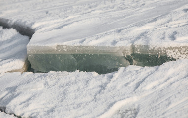 cracked ice surface on the lake