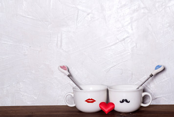 Valentine's day holiday celebration with hearts and cups over bokeh background