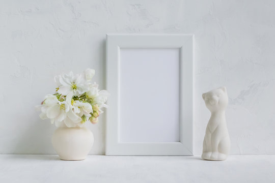 Mockup with a white frame and white spring flowers