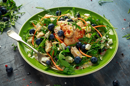 Fresh Chicken salad with Blueberries, feta, carrots, nuts and green vegetables. healthy food concept