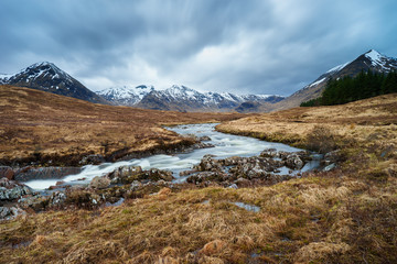 Wild river leading to the scottish mountains