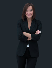 Happy businesswoman wearing black suit standing and folding arms