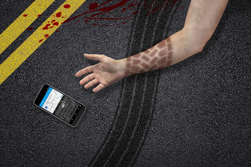 man texting and jaywalking accident hand tire marks phone asphalt