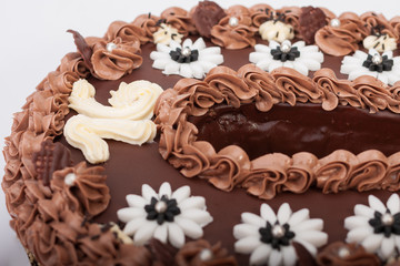 Close up of birthday sponge cake with chocolate cream