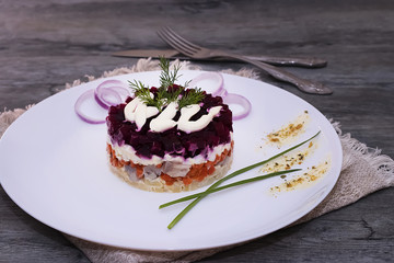 Russian traditional  salad with boiled vegetables and herring.