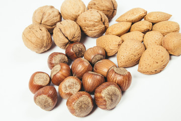 Different types of nuts in a shell on a white background.