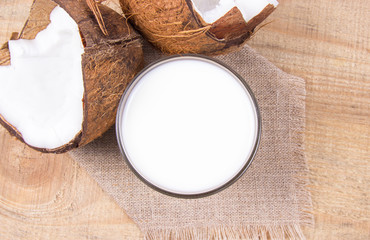 Fototapeta na wymiar Coconut with coconut milk on wooden background.