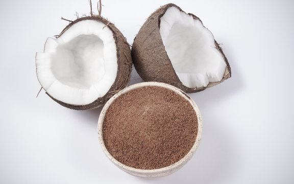 Coconut with coconut sugar isolated on white background.