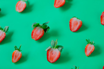 Strawberries isolated on green background.