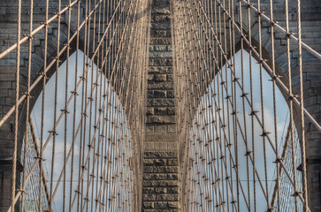 Detail of the Brooklyn Bridge neo-Gothic arches and steel suspension cables, civil engineering...