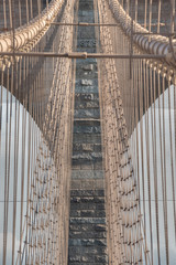 Detail of the Brooklyn Bridge neo-Gothic arches and steel suspension cables, civil engineering masterpiece, New York City