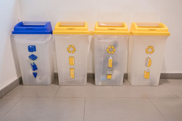 Blue and yellow Garbage containers for recycling .