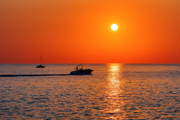 Fototapeta na wymiar Summer. Sea. Sunset on the Black sea. Sochi. Krasnodar Krai. Russia. Yachts floating on the sea.