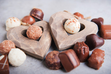 Delicious chocolate candies on a grey background