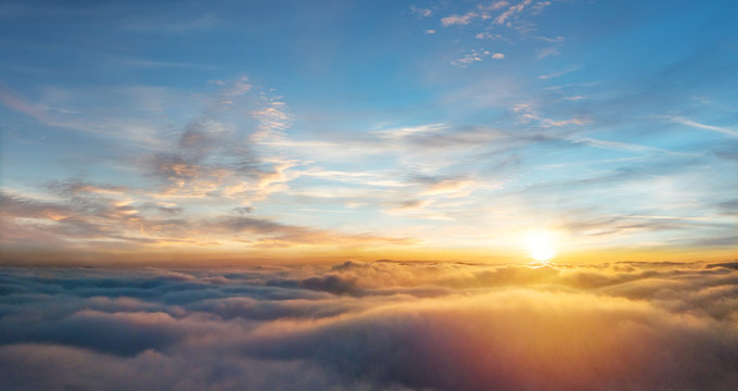 Beautiful aerial view above clouds with sunset