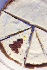 festive cheesecake/ pieces of cake one of which is decorated with a chocolate tree top view