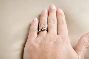 Woman wearing luxury engagement ring, closeup