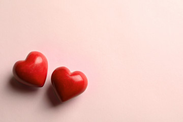 Two red hearts on light background