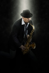Naklejka premium Man playing on saxophone