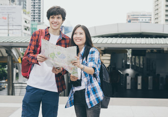 attractive couple young caucasian and asian traveler in modern city Bangkok Thailand with happy and smile.