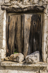 Old wodden window shutter of traditional house in the village Chamaitoulo, Crete, Greece