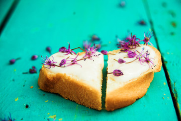 Open faced sandwiches with edible flowers. Top view, blank space