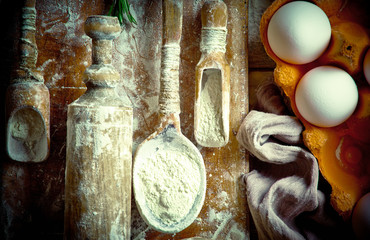 Raw dough with flour on the old background