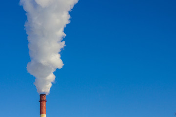Against the background of a cloudless blue sky, a column of white, thick smoke. Harmful emissions...