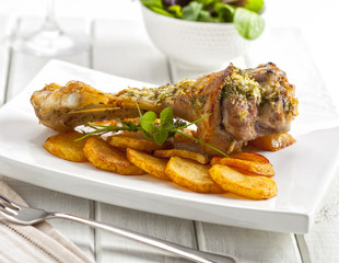 Roasted leg of lamb on a wooden table