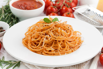 pasta with tomato sauce and ingredients, closeup