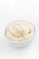 mayonnaise with herbs in a bowl, vertical