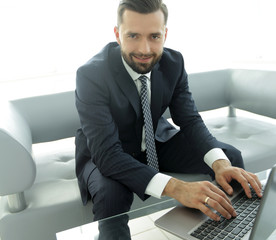 employee of the company typing text on the laptop keyboard