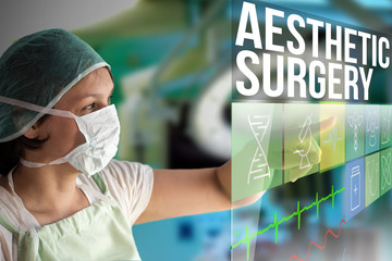 Aesthetic surgery concept. Doctor using a futuristic touch screen concept computer with medical icons on it. Healthcare operation surgery room on background.