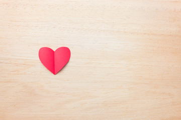 Red paper heart on wooden background, love and valentine concept